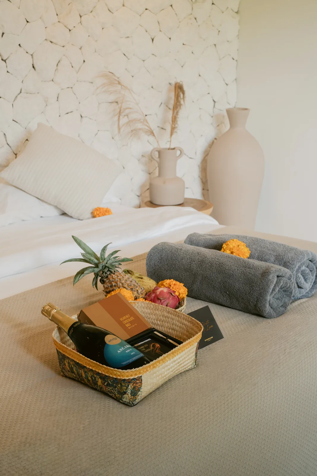 Romantic villa setup with flowers, fruit, sparkling wine and massage towels