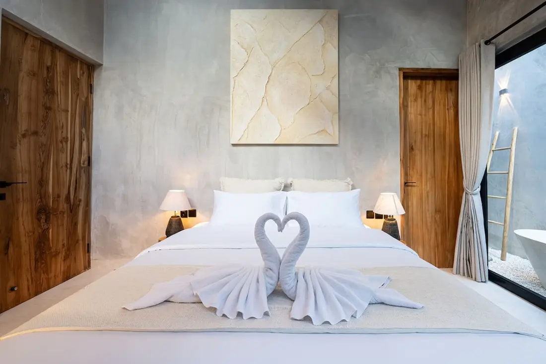 Ayla Villa bedroom prepared with two towel swans forming a heart on the bed